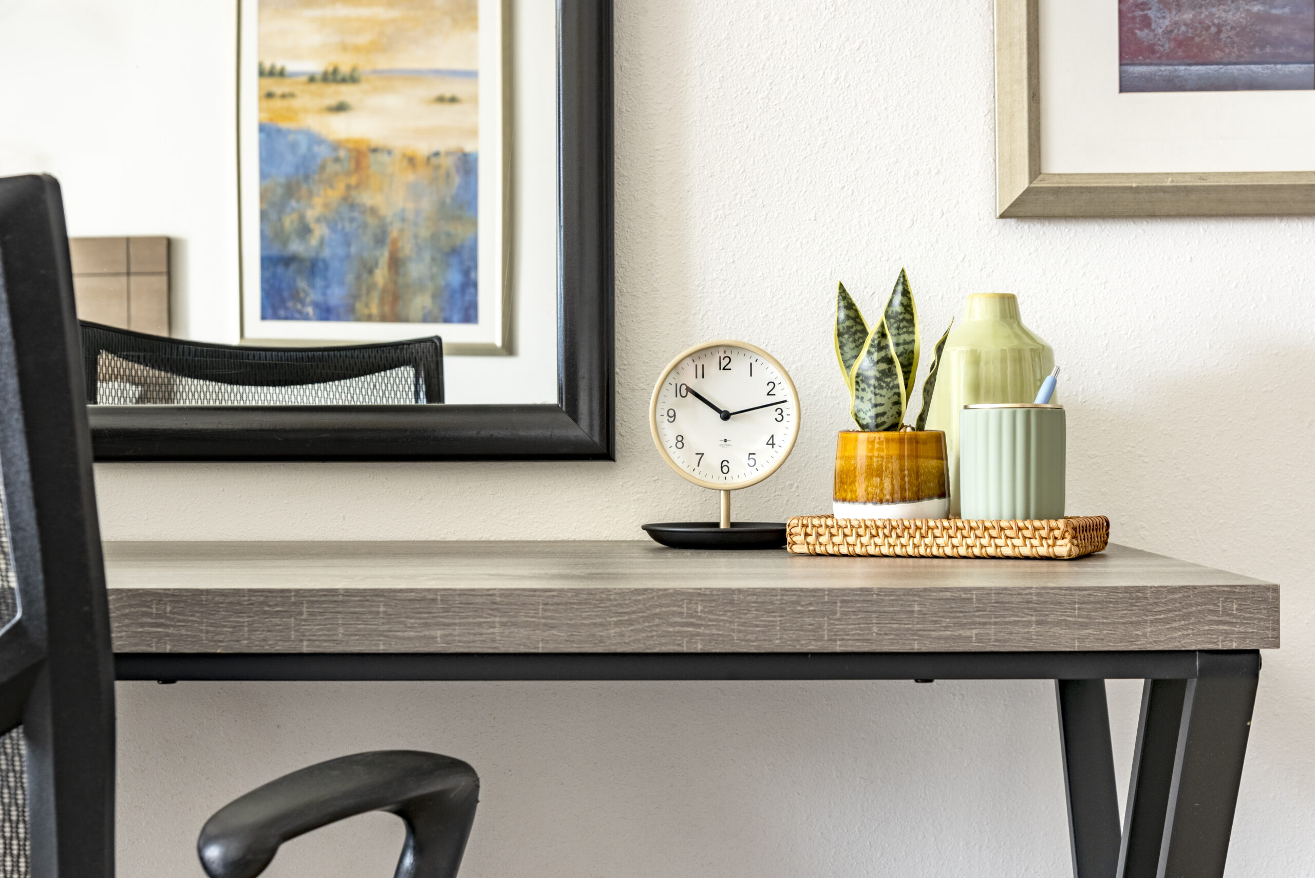 Desk with clock and decor in furnished room at The Residences, Hadley, MA