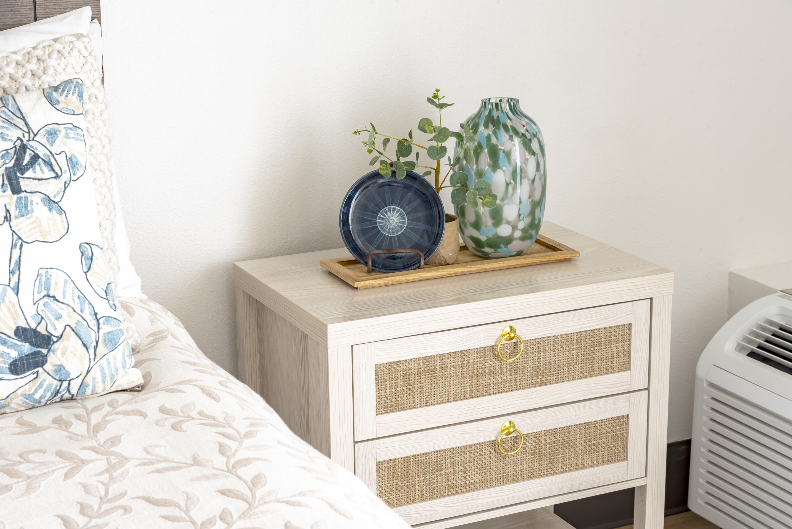 Nightstand with vases and decor detail at The Residences, Hadley, MA