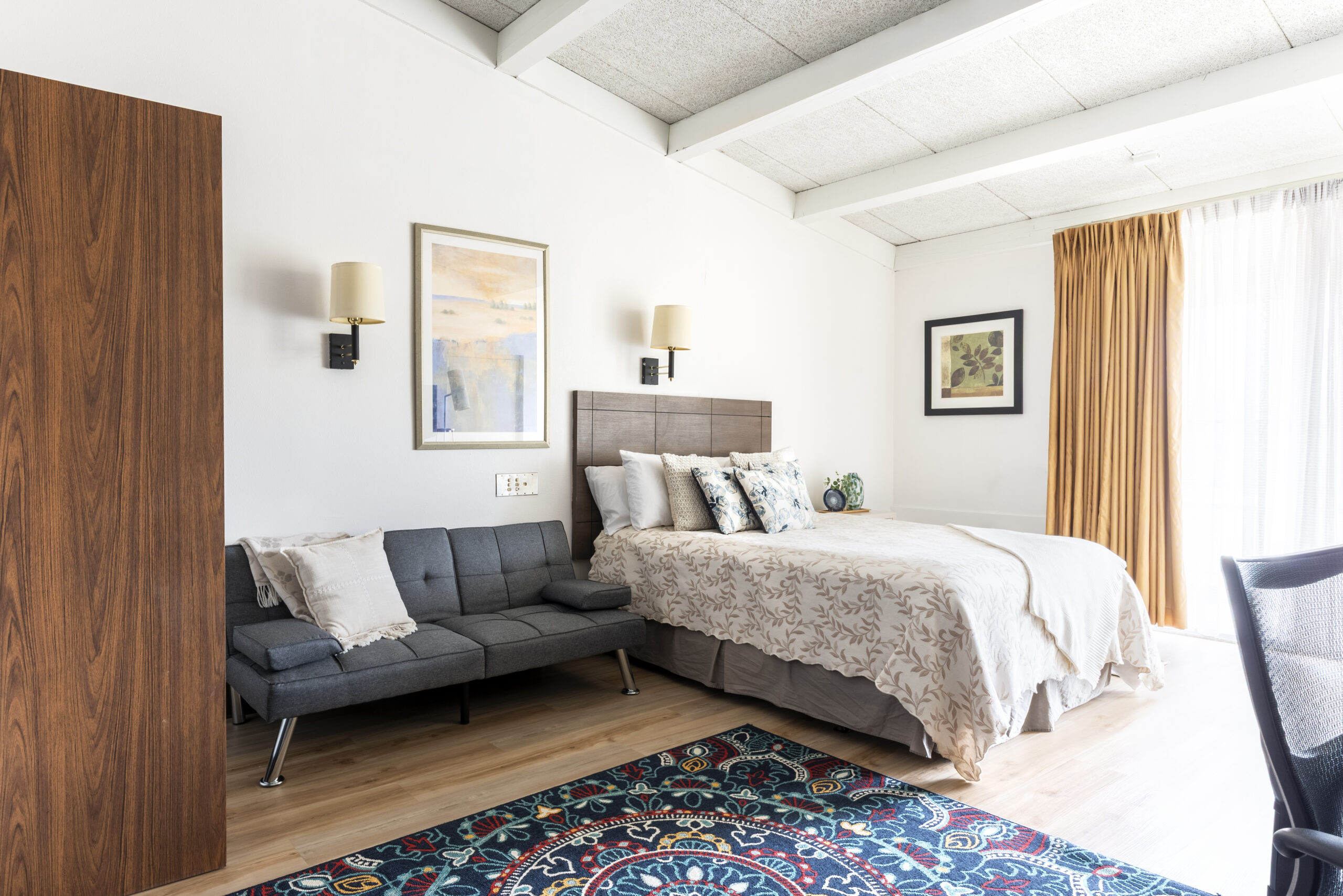 Queen bed and futon seating at The Residences, Hadley, MA