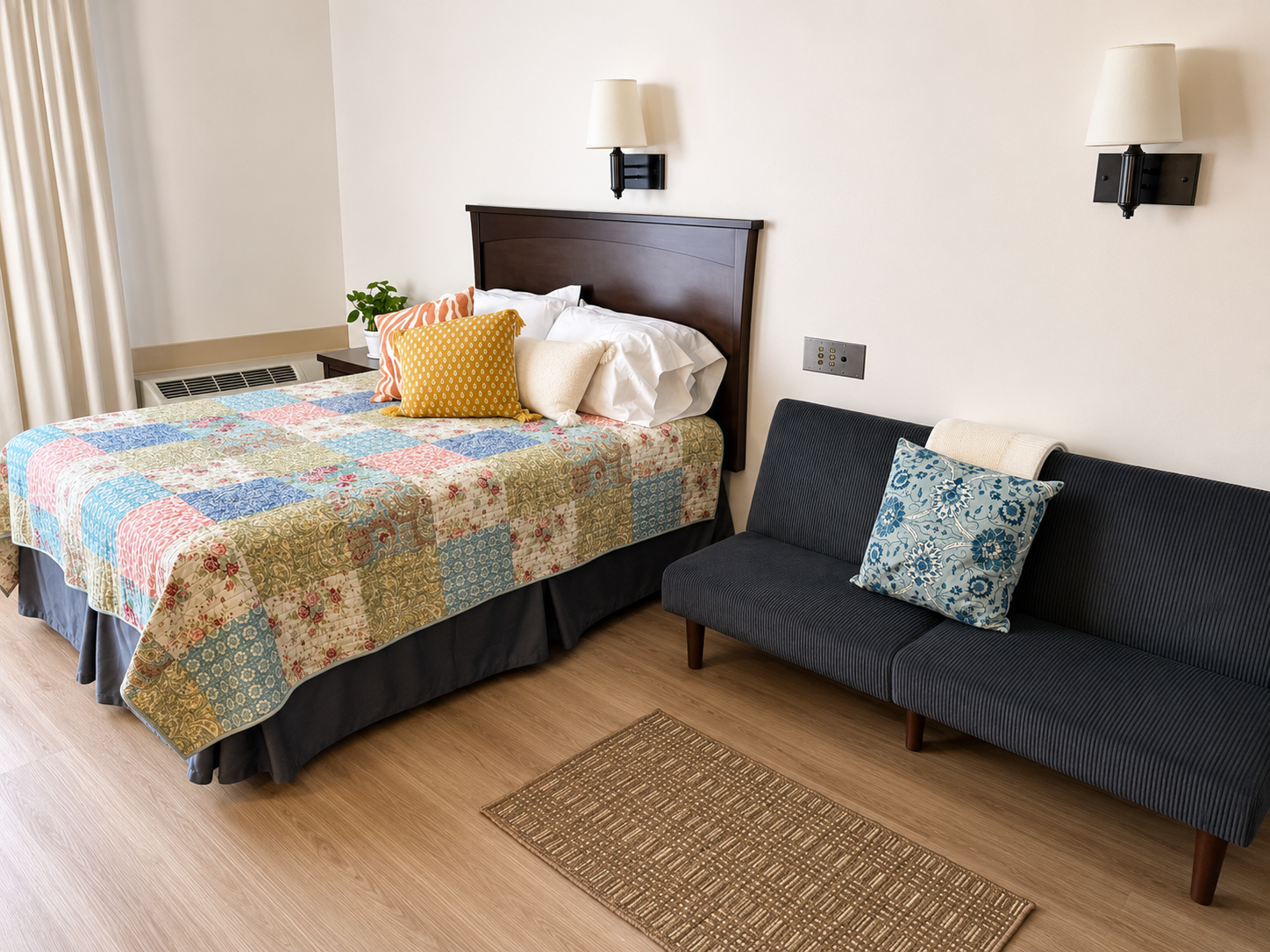 Furnished bedroom at The Residences Hadley, queen bed and loveseat