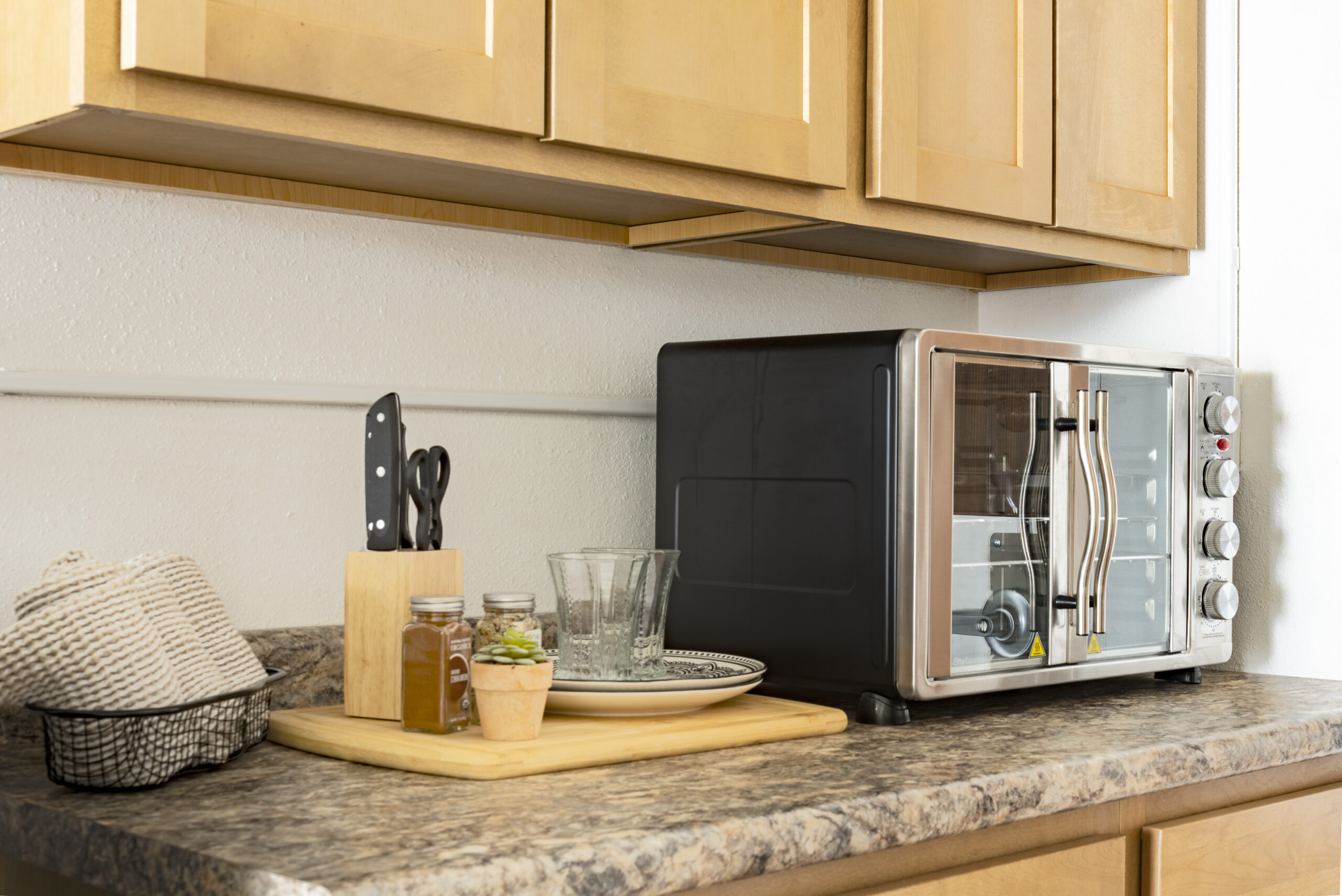 Kitchenette counter with toaster oven and appliances at The Residences, Hadley, MA