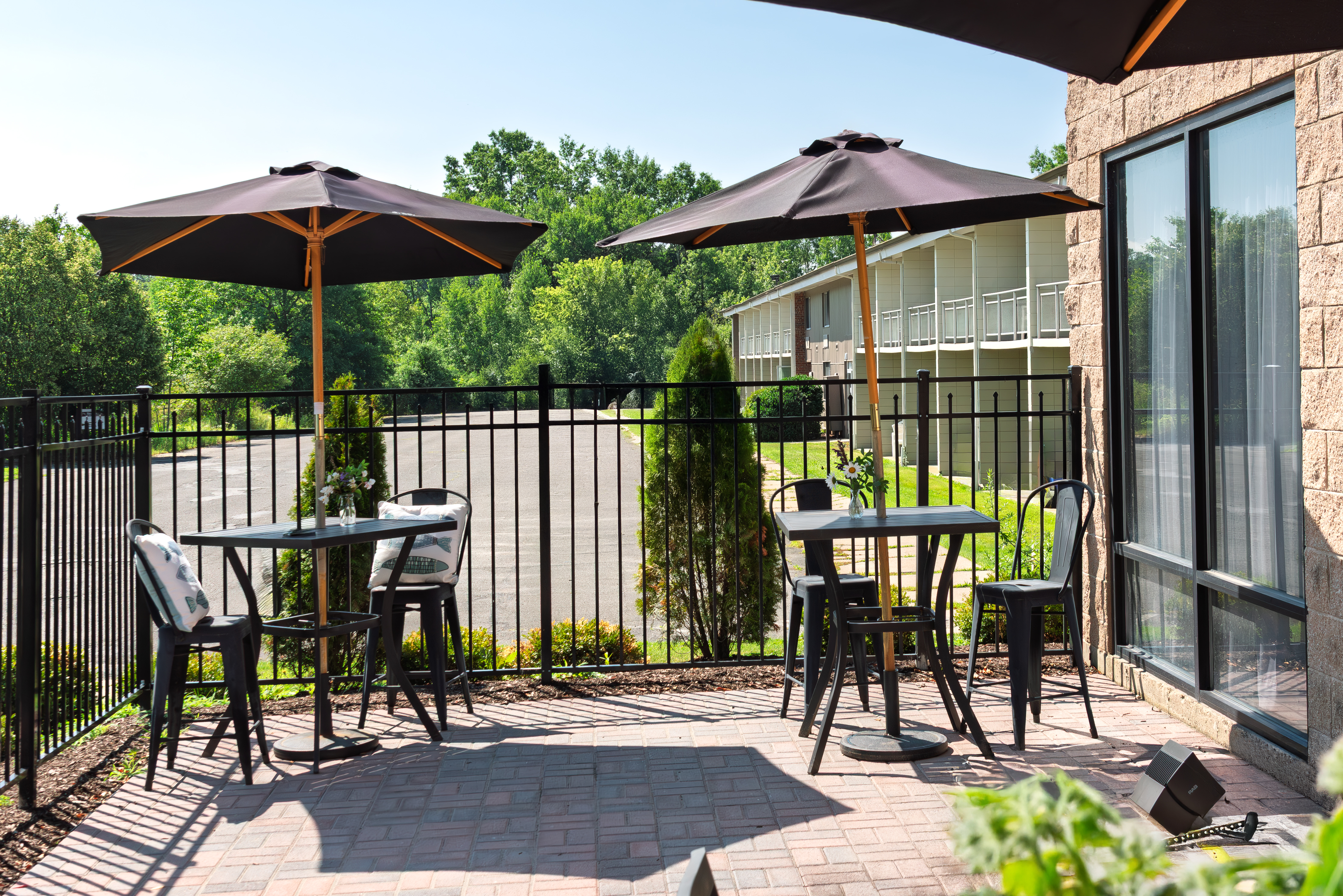 Outdoor patio with two tables and seating at The Residences in Hadley, MA