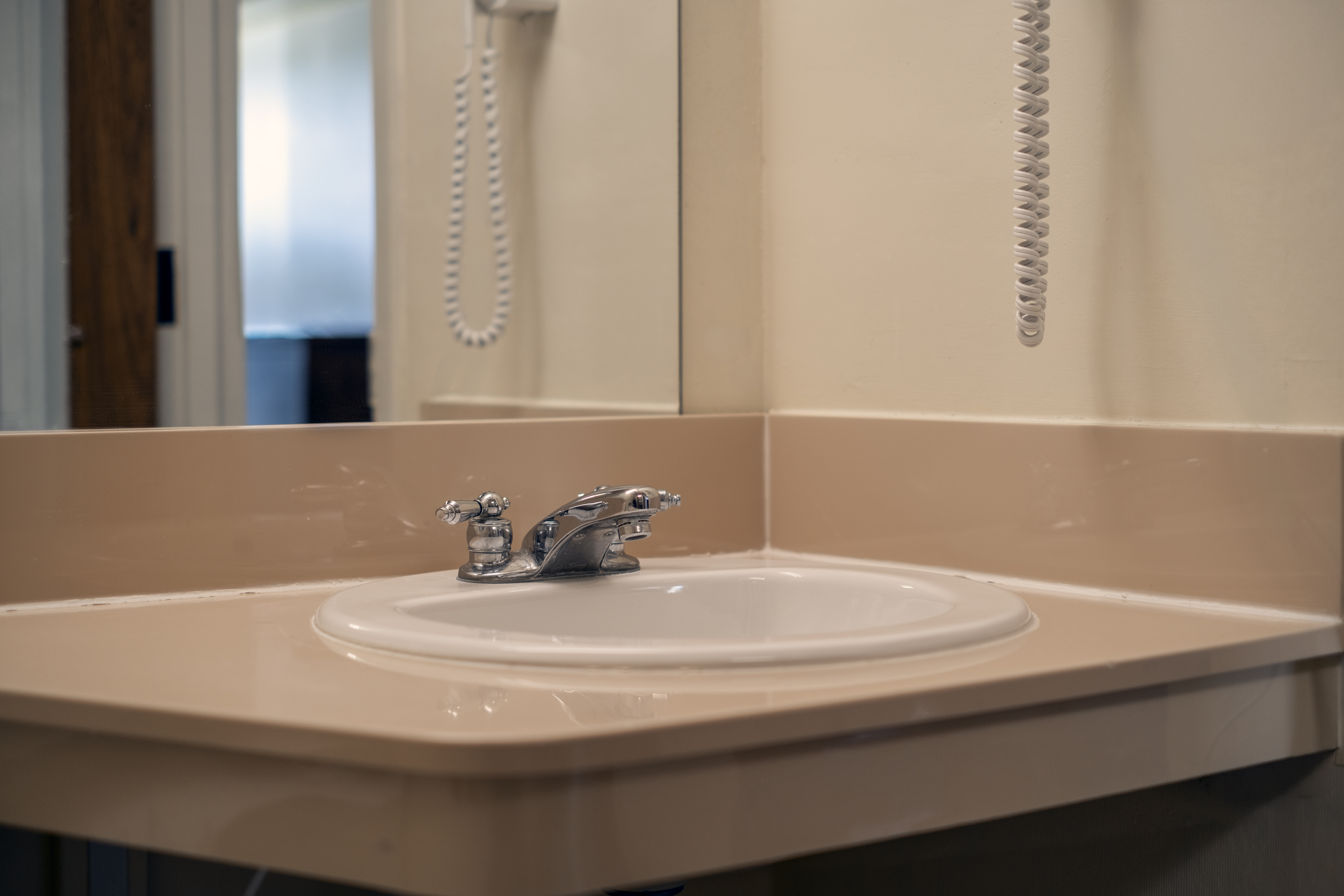 Bathroom vanity countertop and mirror detail at The Residences, Hadley, MA