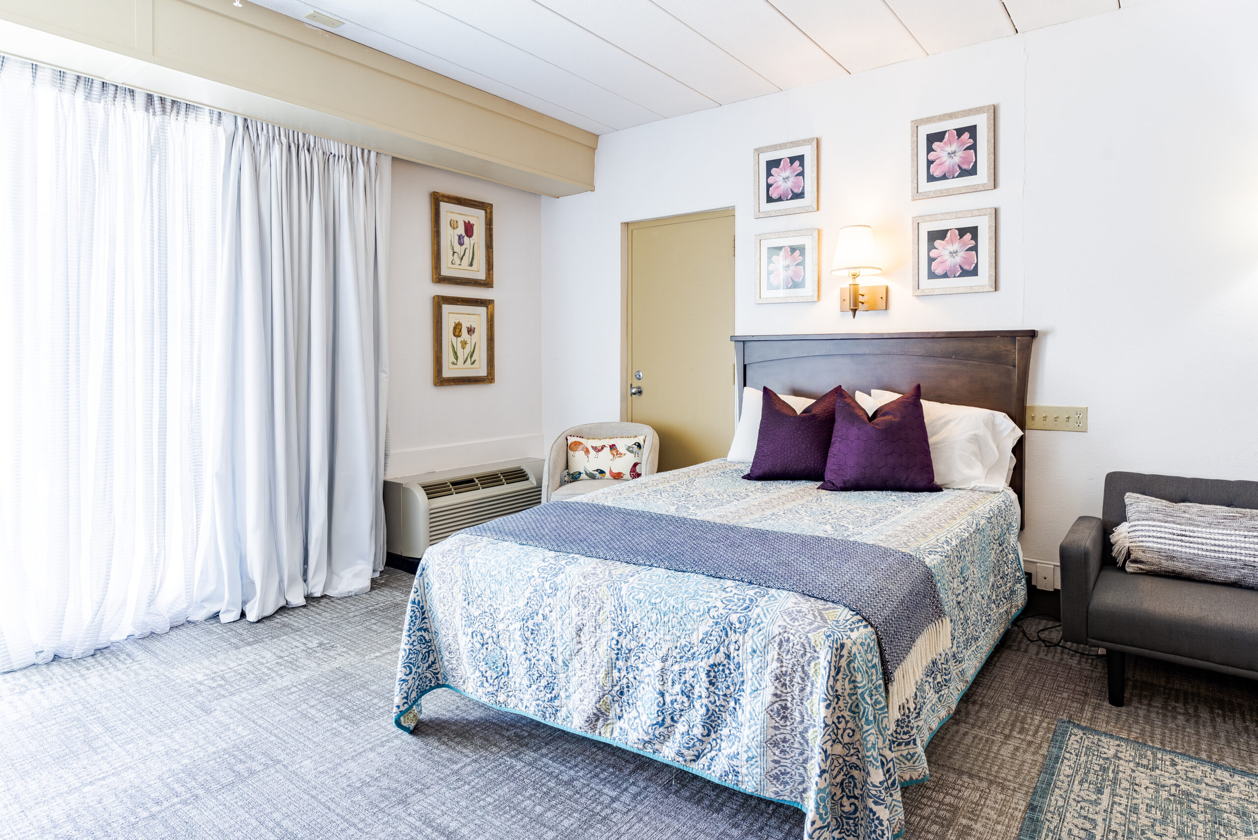 Fully furnished bedroom with patio view at The Residences Hadley MA