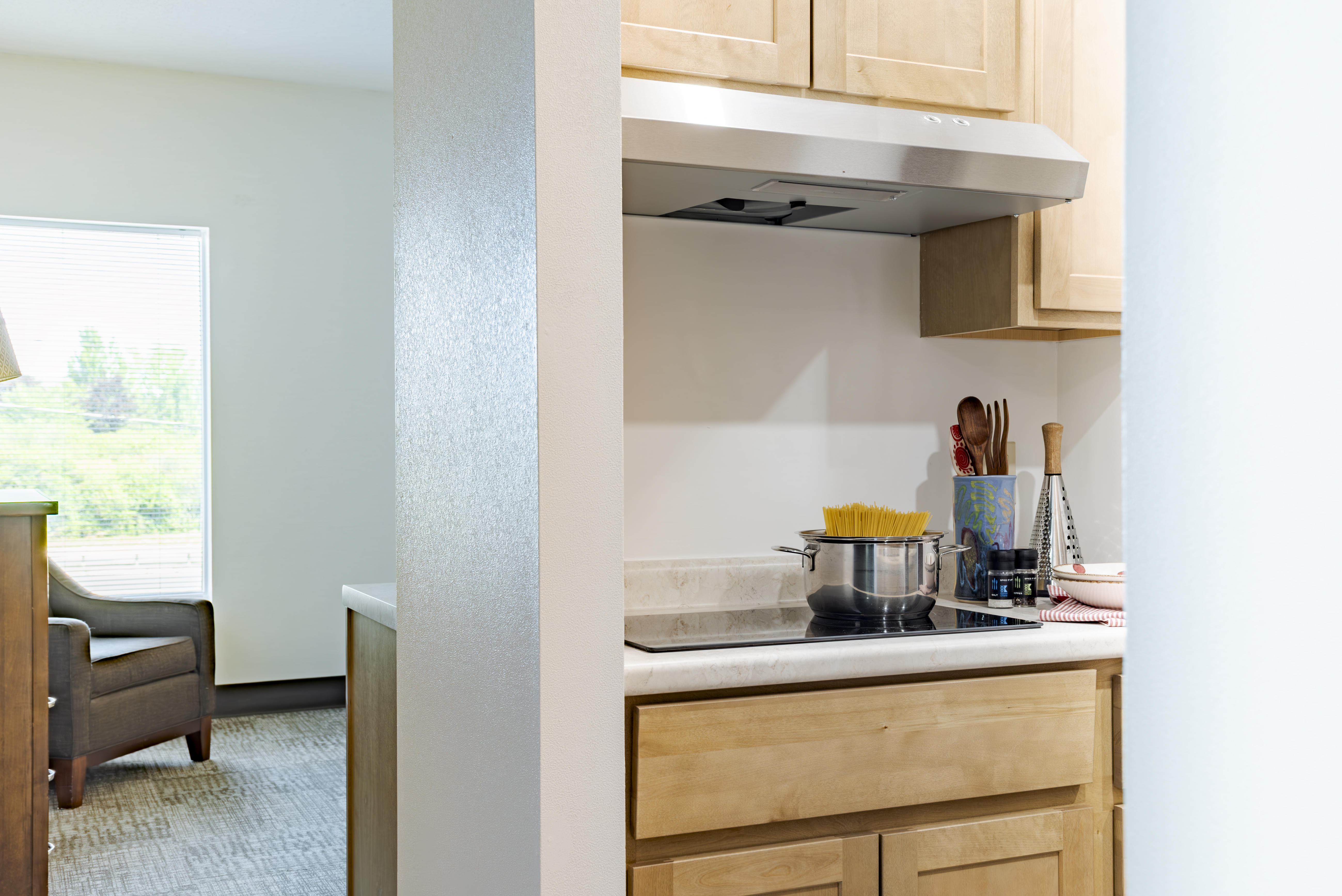 Kitchen stovetop with range hood at The Residences, Hadley, MA